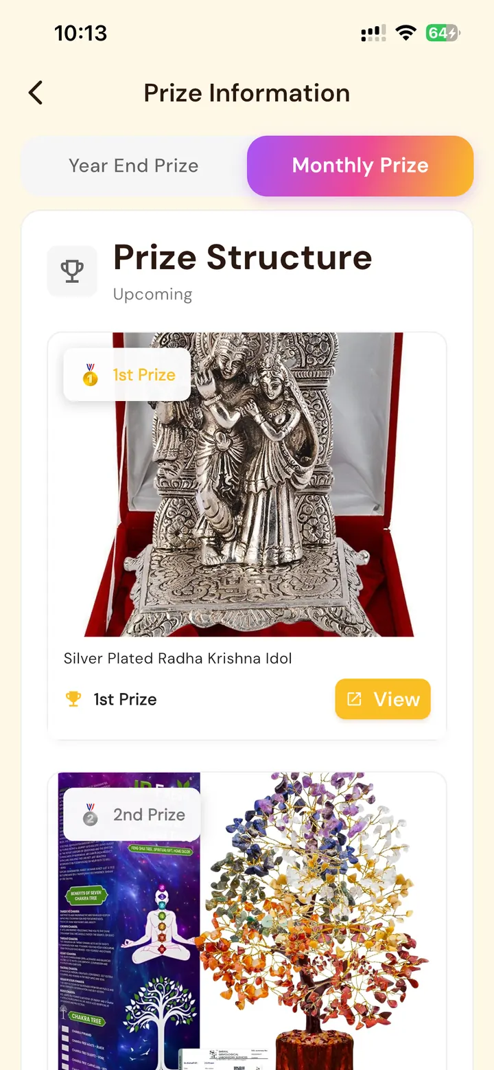 Monthly streak prize screen featuring devotional rewards including a silver-plated Radha Krishna idol and gemstone tree